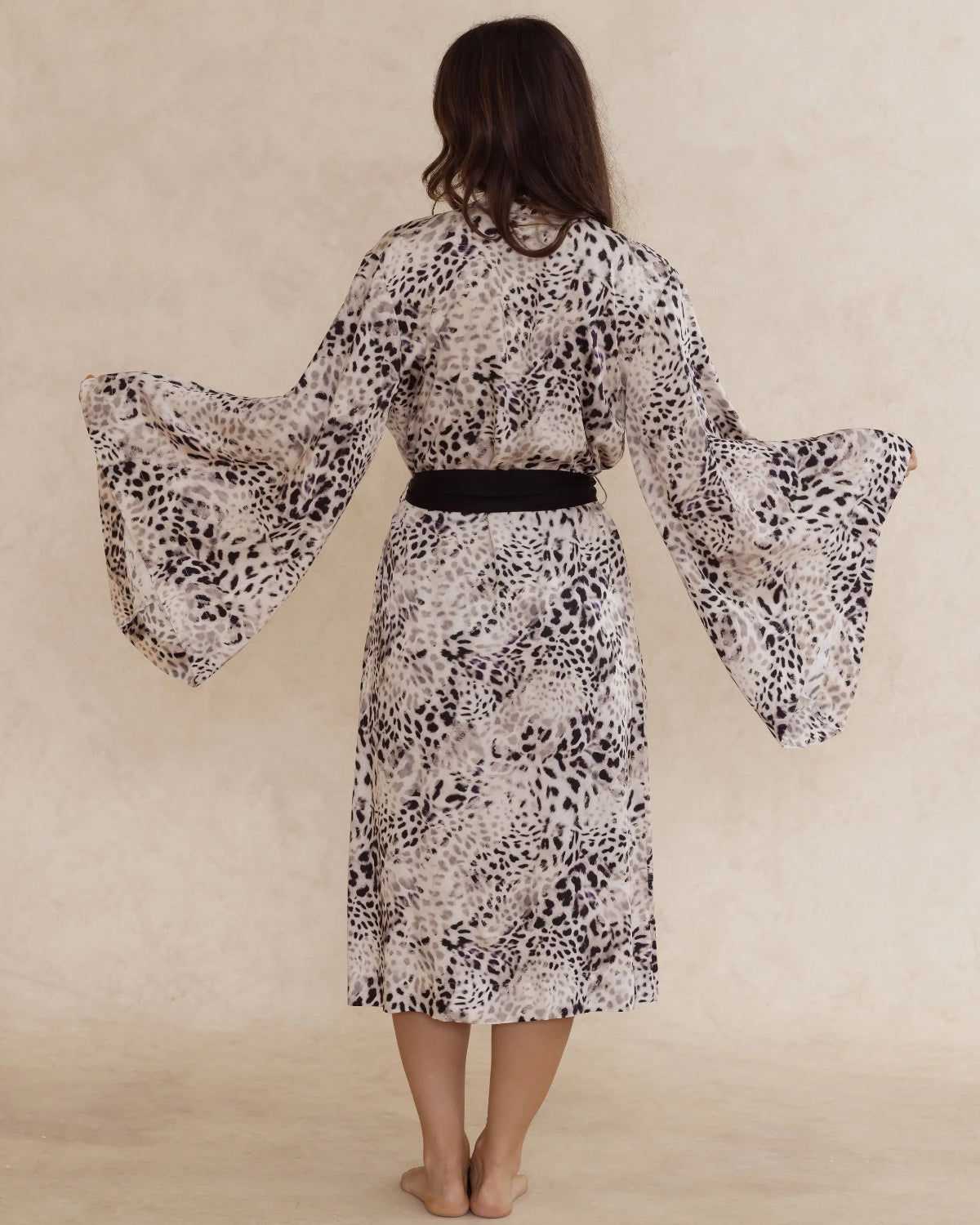 Back view of a woman wearing an animal print kimono style robe, with an adjustable waist tie – bamboo robe, lightweight, breathable luxury women’s sleepwear designed in Australia.