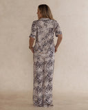 Back view of a woman wearing animal print bamboo pyjama set with short sleeves and long pants. with pockets – soft, breathable women’s sleepwear designed in Australia