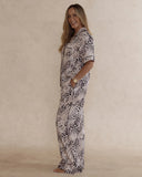 Woman wearing animal print bamboo pyjama set with short sleeves and long pants. with pockets – soft, breathable women’s sleepwear designed in Australia