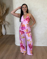 Woman wearing a pink floral cami top with v-neckline and matching pants. Made from silky soft bamboo satin.