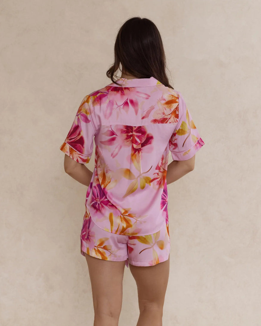 Back view of a woman wearing a pink floral bamboo pyjama set – soft, breathable luxury sleepwear for women designed in Australia