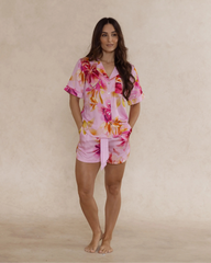Woman wearing a pink floral bamboo pyjama set – soft, breathable luxury sleepwear for women designed in Australia