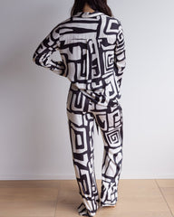 Back of a black and cream pj set with long sleeves and pants, made of silky soft bamboo satin