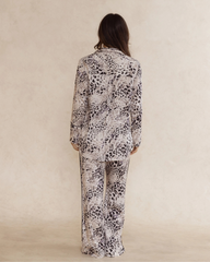 Back view of a woman wearing animal print bamboo pyjama set with long sleeves and long pants, with pockets – soft, breathable women’s sleepwear designed in Australia.