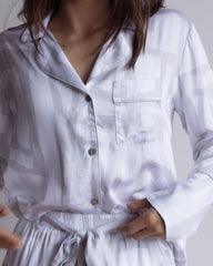 Woman wearing silky soft bamboo loungewear in a white and grey print