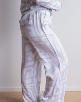 Silky-soft, breathable bamboo loungewear pants, with an elasticated waistband and pockets. Geometric pattern in white and grey.