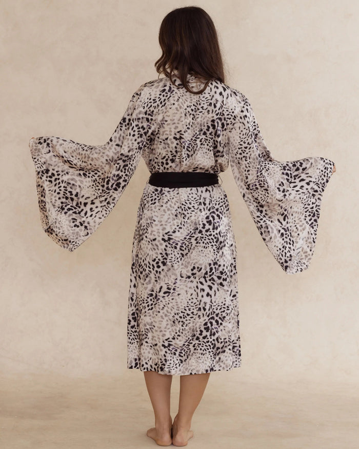 Back view of a woman wearing an animal print kimono style robe, with an adjustable waist tie – bamboo robe, lightweight, breathable luxury women’s sleepwear designed in Australia.