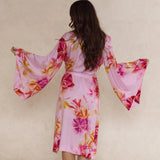 Pink floral kimono style robe with waist tie, dramatic draped sleeves, made from silky soft bamboo satin.