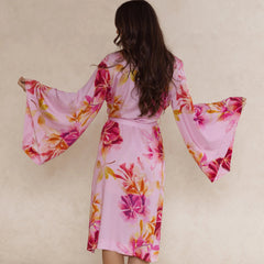 Pink floral kimono style robe with waist tie, dramatic draped sleeves, made from silky soft bamboo satin.