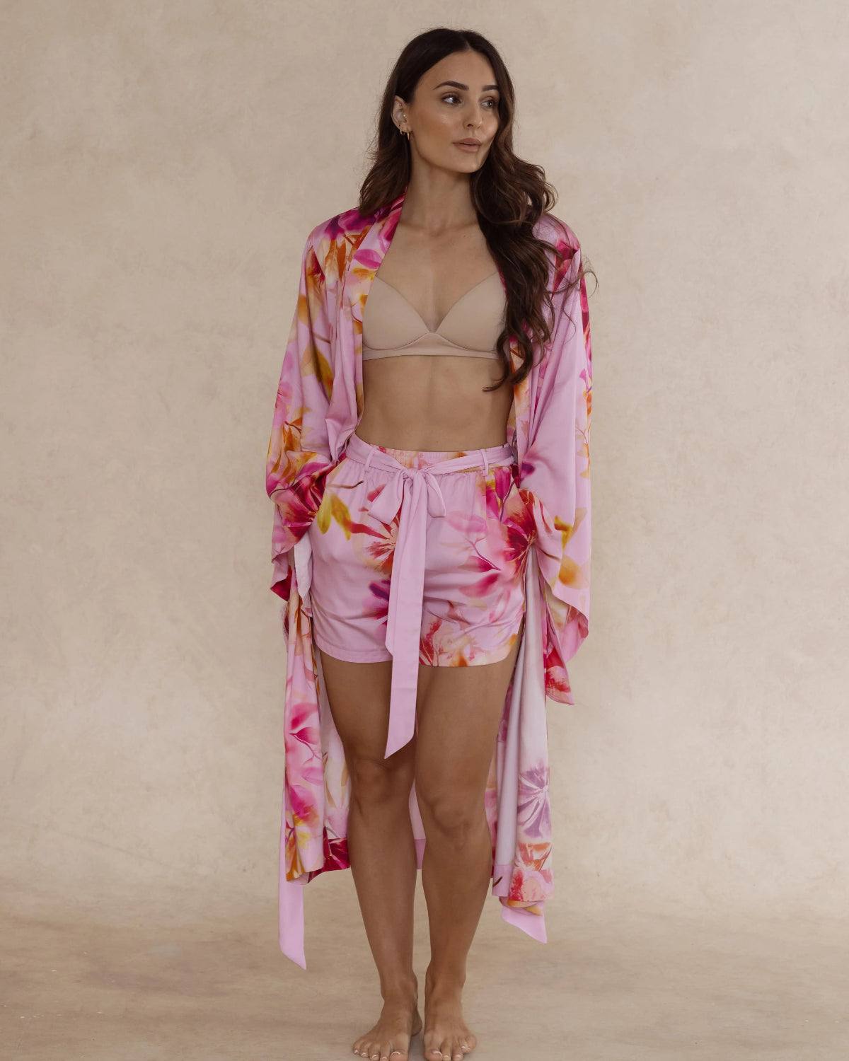 Woman in floral bamboo pyjama shorts and kimono style robe. Both with pockets and tie – soft, breathable women’s sleepwear designed in Australia.