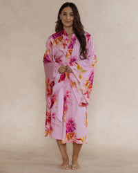Woman in pink floral bamboo kimono style robe – elegant, breathable luxury sleepwear for women designed in Australia.