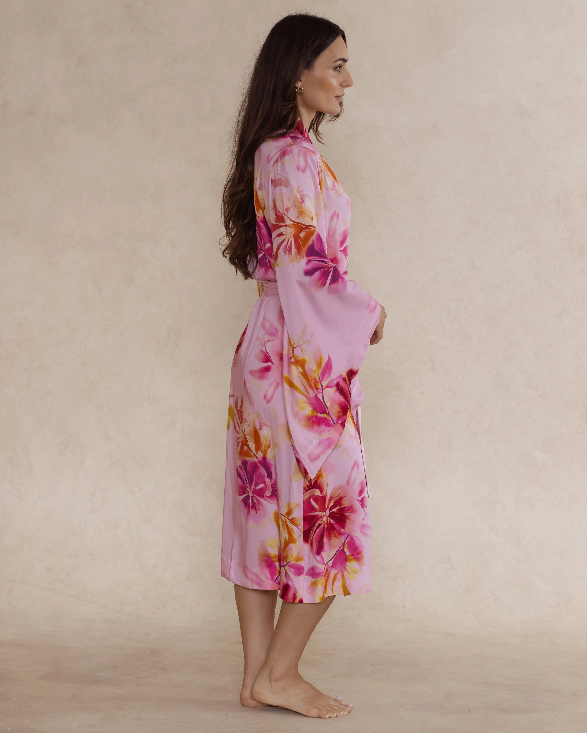 Woman in pink floral bamboo kimono style robe – elegant, breathable luxury sleepwear for women designed in Australia.