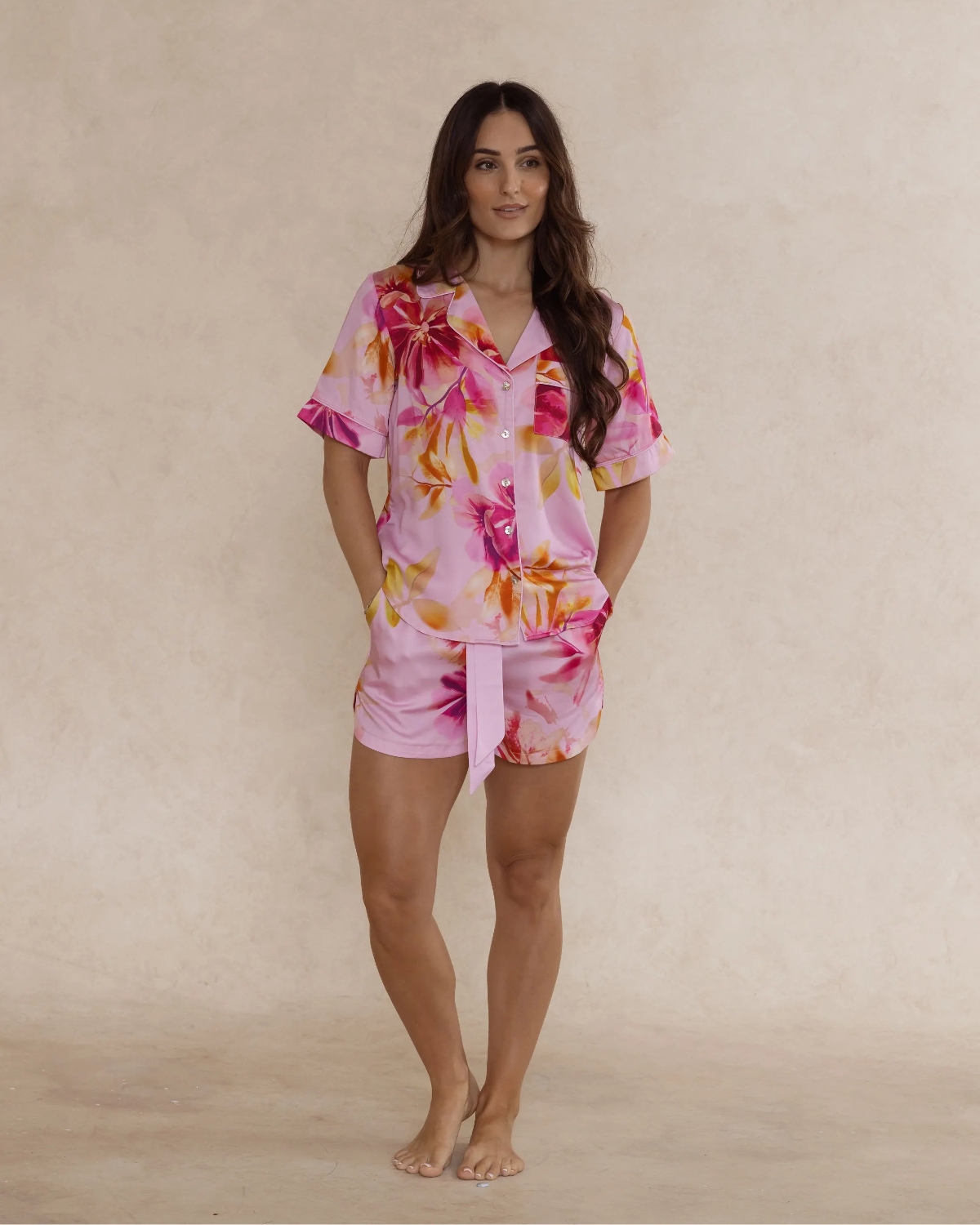 Woman wearing a pink floral bamboo pyjama set – soft, breathable luxury sleepwear for women designed in Australia