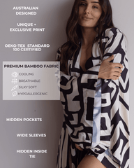 Woman hugging herself in a beautiful silky soft kimono-style robe, with wide sleeves, hidden pockets and hidden inside tie. Text on the image highlights the benefits of bamboo satin; breathable, cooling, silky soft and hypoallergenic.