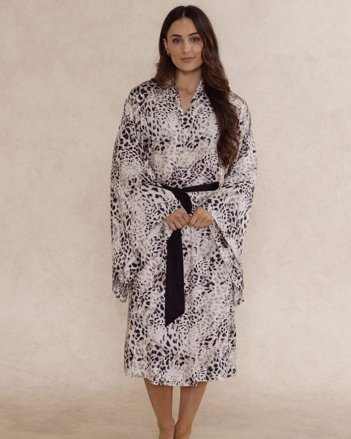 Woman wearing a animal print kimono style robe, with an adjustable waist tie and pockets – bamboo robe, lightweight, breathable luxury women’s sleepwear designed in Australia.