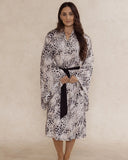 Woman wearing a animal print kimono style robe, with an adjustable waist tie and pockets – bamboo robe, lightweight, breathable luxury women’s sleepwear designed in Australia.