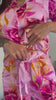 Women wearing and reviewing a pink floral bamboo pyjama set. With elegant piping, pockets, waist tie and shell buttons.