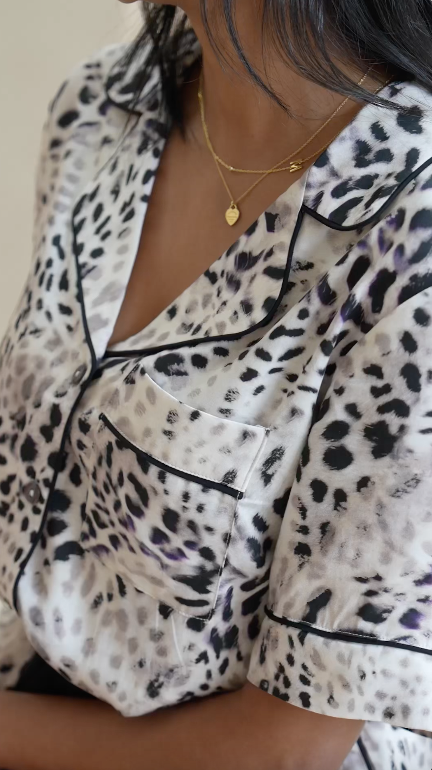 Try on video of short women's pyjama set in muted leopard print. Silky soft bamboo satin, with elegant piping, pockets and waist tie.