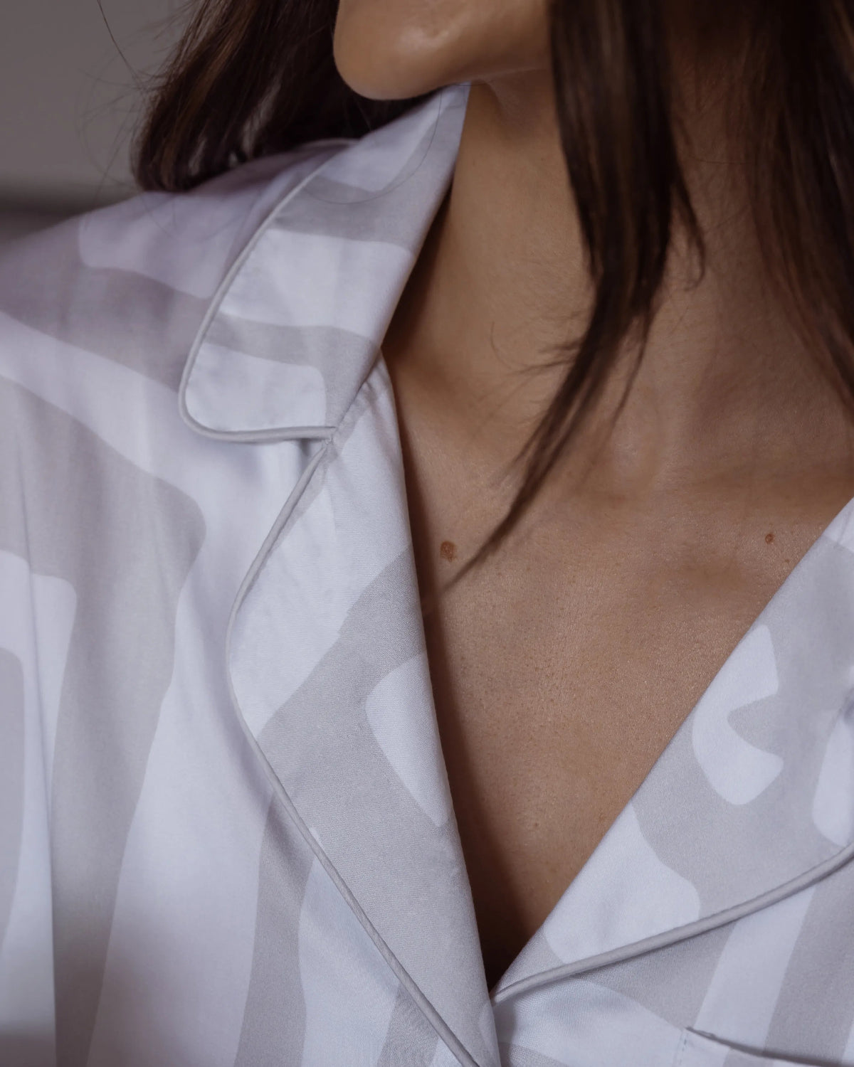 Close-up of silky-soft bamboo satin pyjama collar with piping – luxury sleepwear